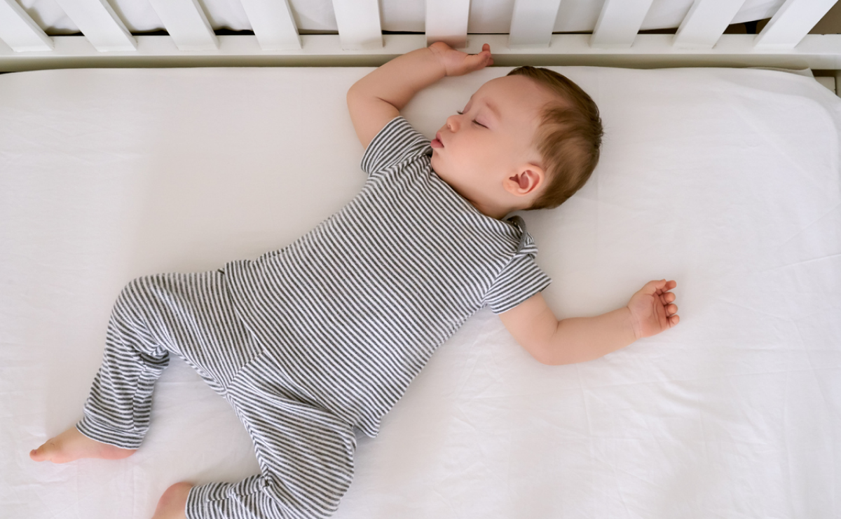 Toddler boy sleeping in crib