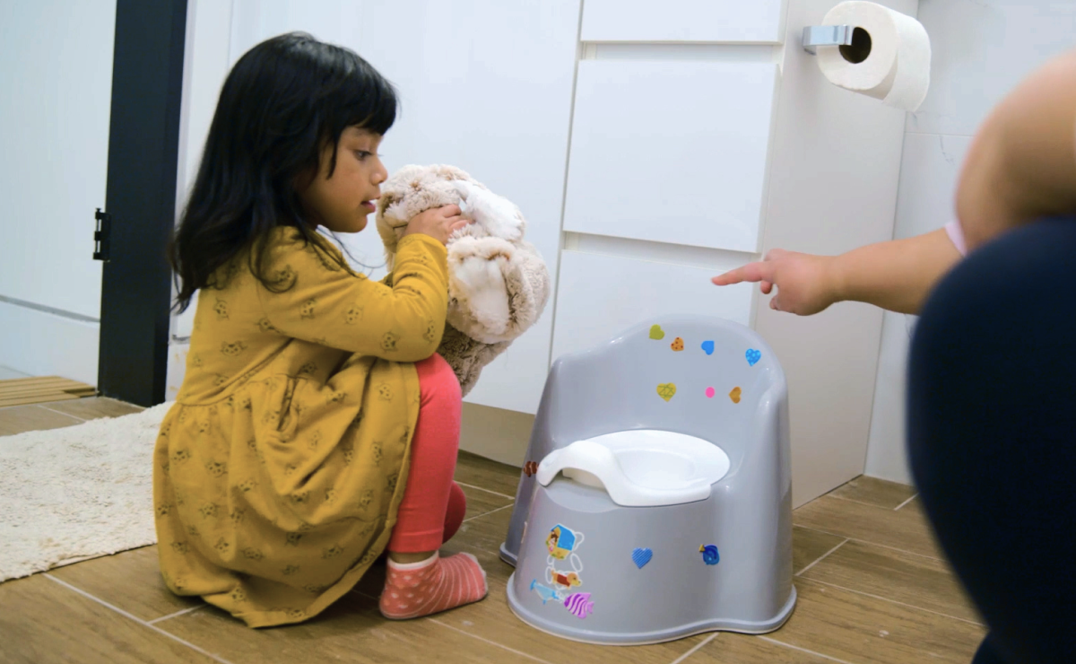 Young girl looking at potty 