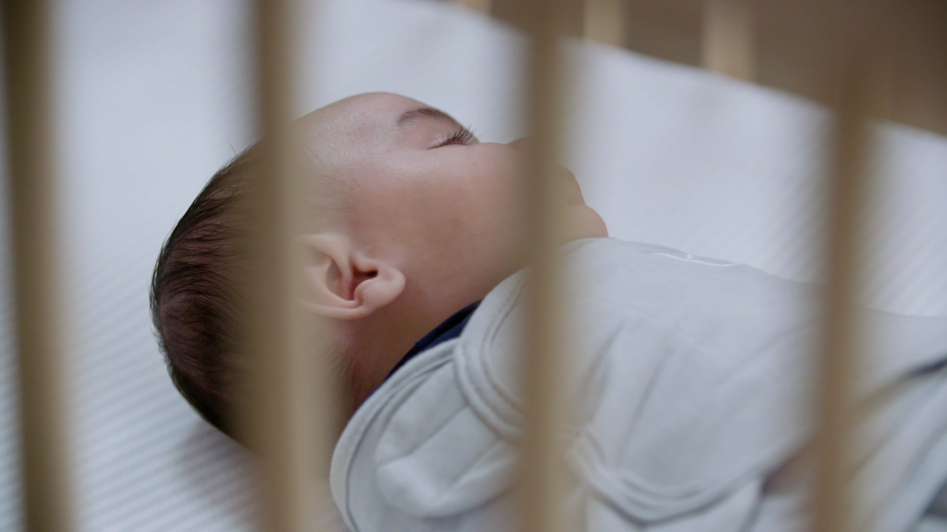 Baby sleeping in empty crib