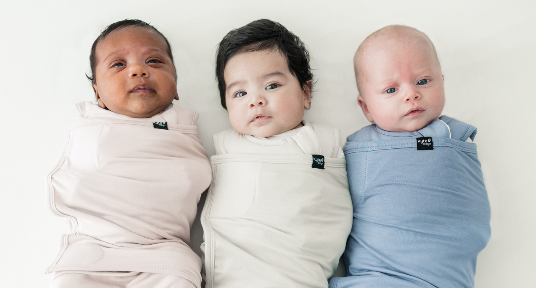 Three babies in Kyte Baby swaddles